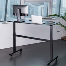Lifestyle image of the Tranzendesk 55" stand up desk in an office setting.