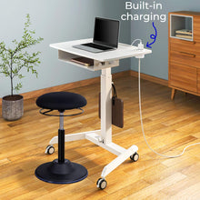 White | Lifestyle image of the Cruizer mobile height adjustable desk in a home office setting. 