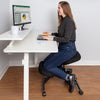 Lifestyle image of the pneumatic kneeling chair by Stand Steady in an office setting.