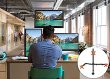 Lifestyle image of the Stand Steady triple monitor mount in an office setting.