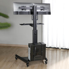 The Dual Monitor Mount Mobile Workstation with Keyboard Tray by Stand Steady in a home office environment.