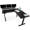 Black | with-shelf | The Tranzendesk electric l-shaped standing desk with shelf and props on it.