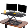 Black | The X-Elite Premier corner desk converter in black can take your desk from sitting to standing in seconds.