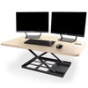 Maple | This spacious maple desktop has plenty of room for all of your wrokplace necessities including multiple monitors, a laptop, keyboard, and more.